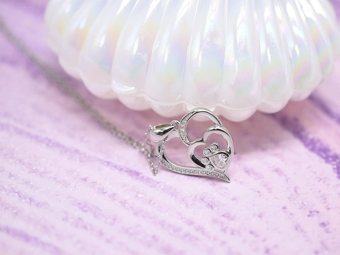 Sterling silver necklace with paw print and heart, set with zirconia.
