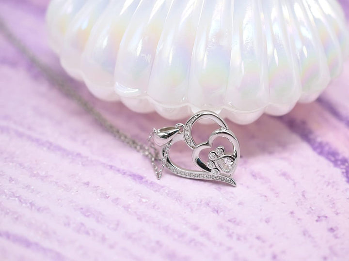 Sterling silver necklace with paw print and heart, set with zirconia.
