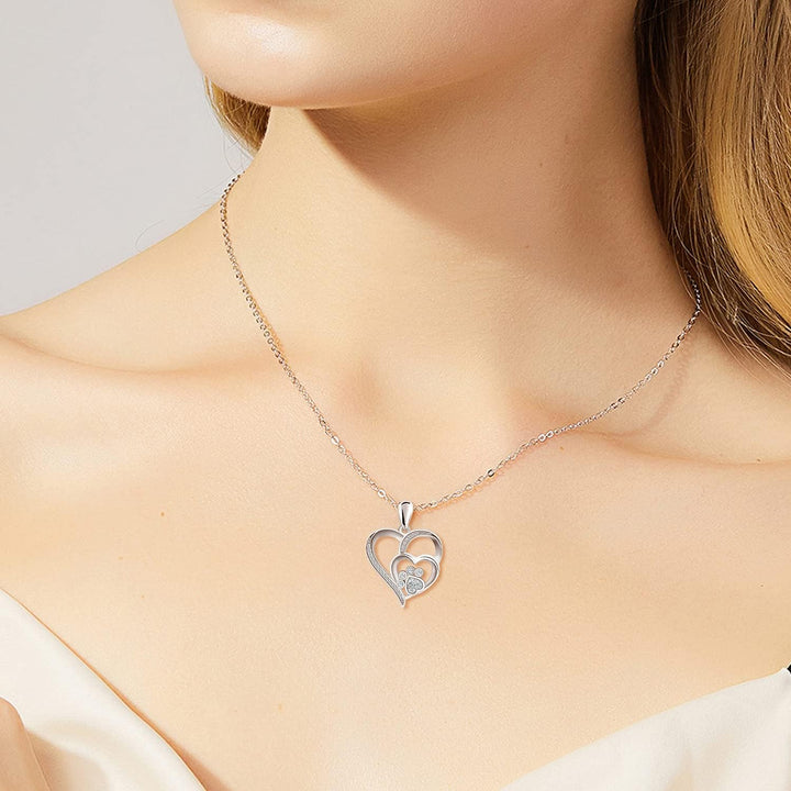 Sterling silver necklace with paw print and heart, set with zirconia.