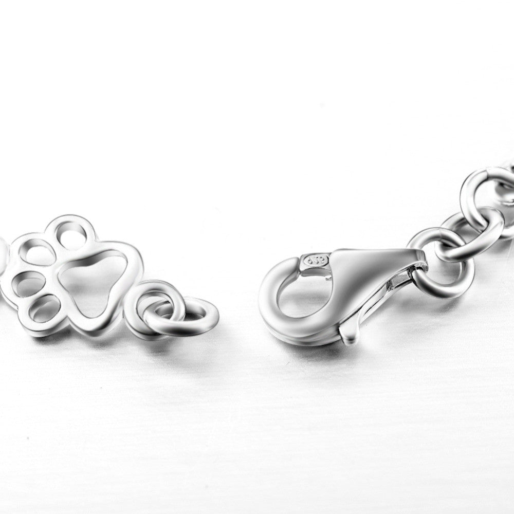 Silver bracelet with dog paw and bone charm