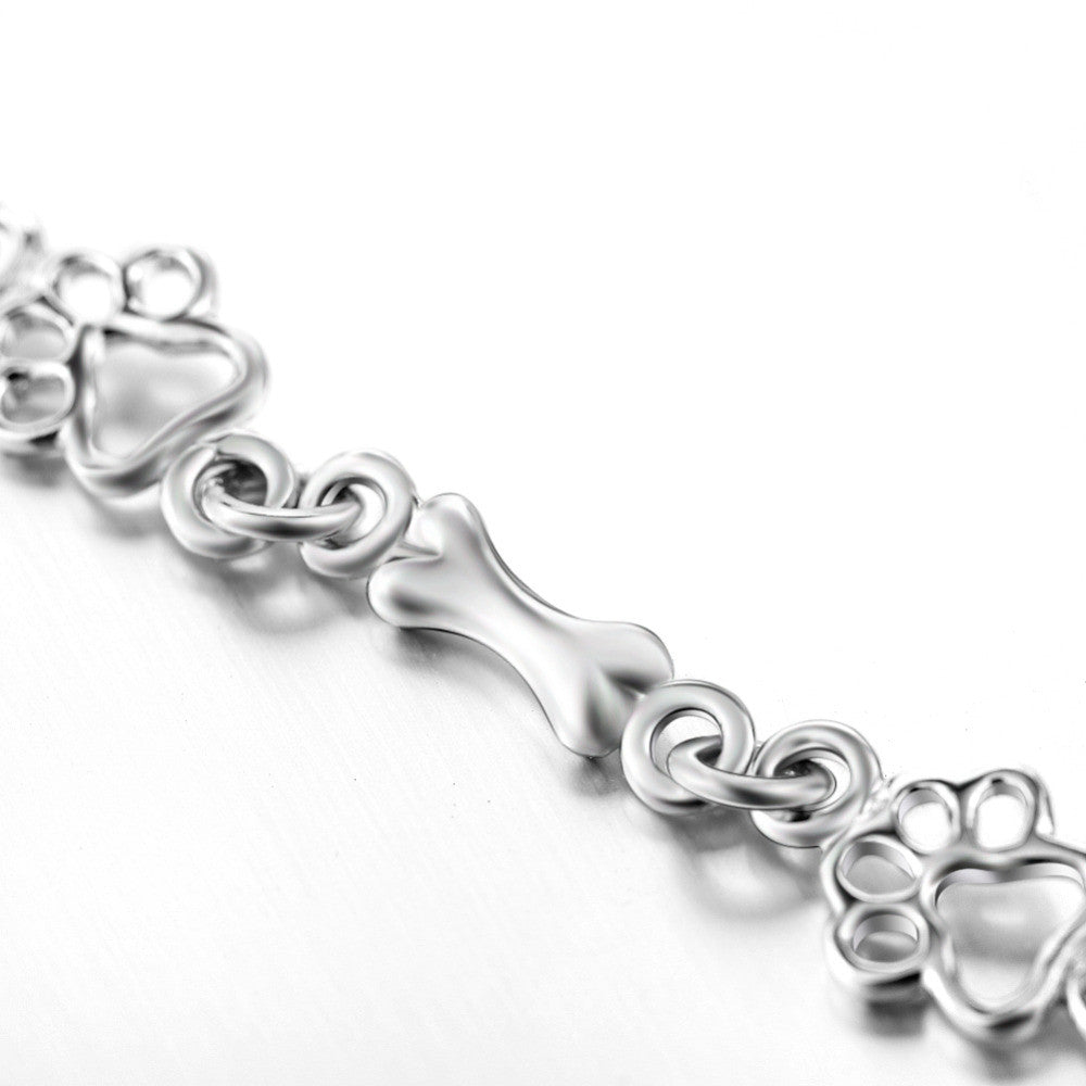 Silver bracelet with dog paw and bone charm