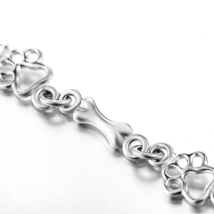 Silver bracelet with dog paw and bone charm