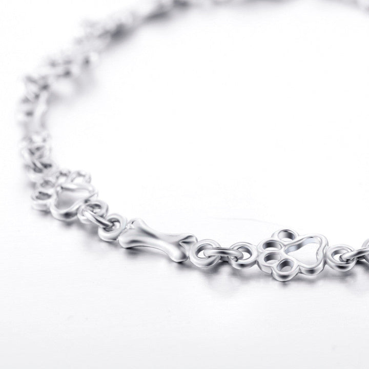Silver bracelet with dog paw and bone charm