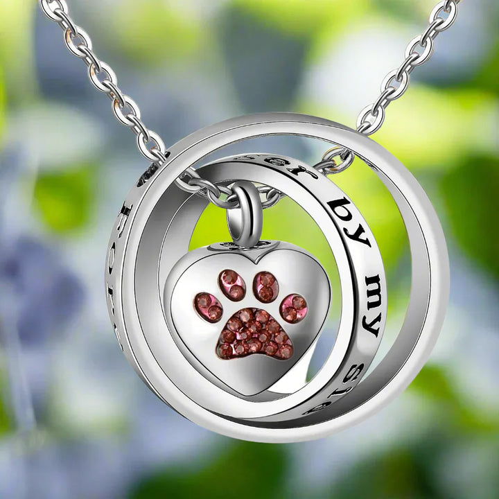 Necklace with urn in the shape of a paw print made of stainless steel