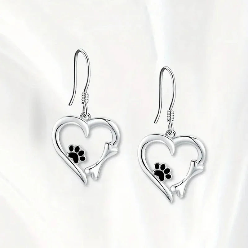 Silver dangling earrings with heart and paw print motif