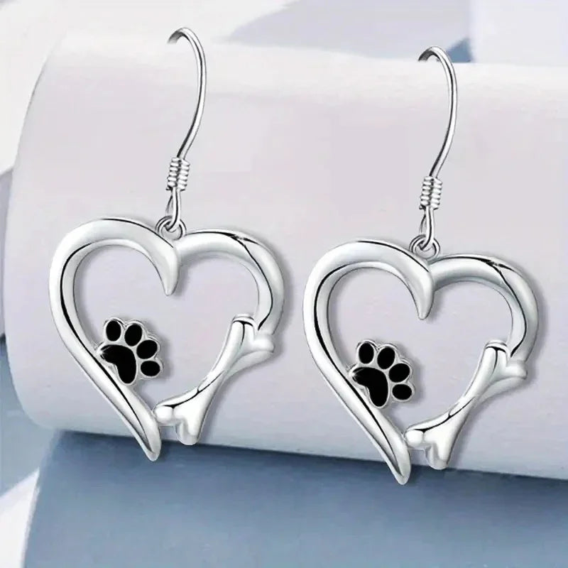 Silver dangling earrings with heart and paw print motif