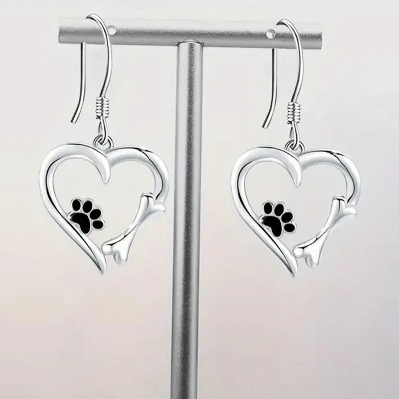 Silver dangling earrings with heart and paw print motif