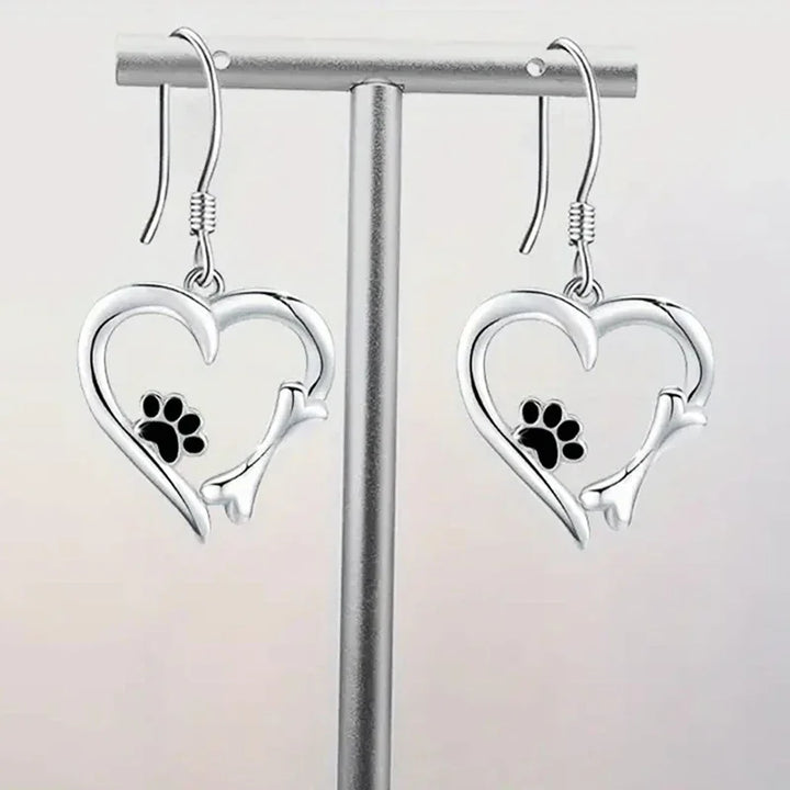 Silver dangling earrings with heart and paw print motif