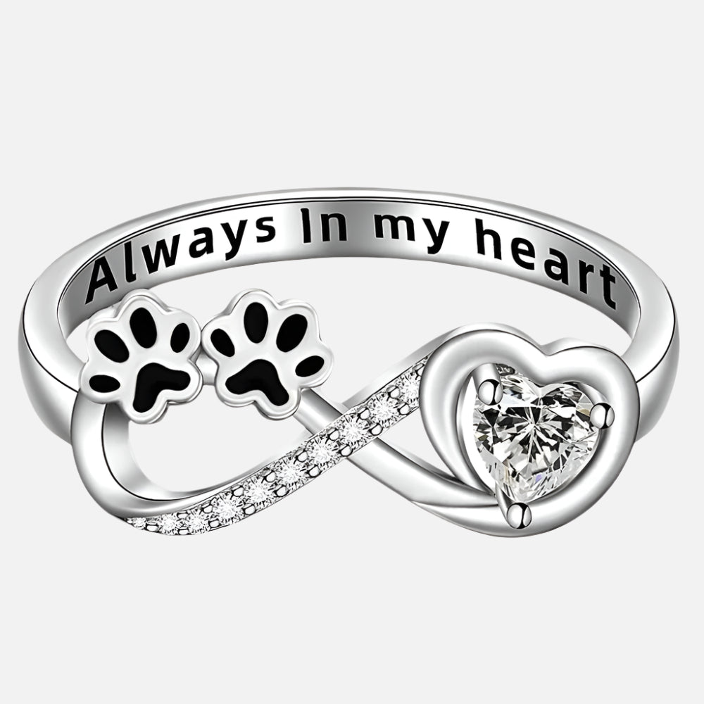 Ring with paw-shaped zirconia, heart and infinity symbol.