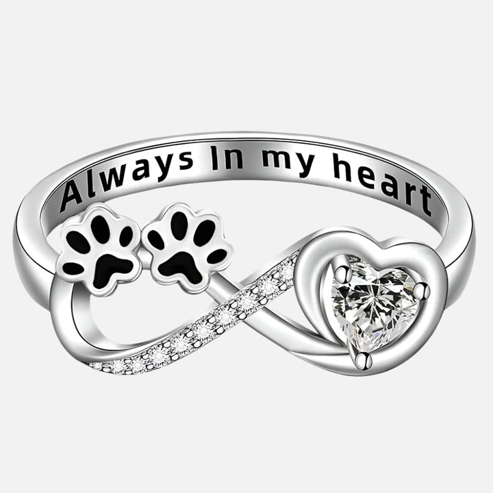 Ring with paw-shaped zirconia, heart and infinity symbol.